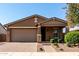 Inviting single-Gathering home featuring a two-car garage, low maintenance landscaping, and covered porch at 10307 E Tiburon Ave, Mesa, AZ 85212