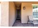 Cozy covered front porch with outdoor seating area and decorative lantern at 10307 E Tiburon Ave, Mesa, AZ 85212