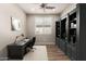 Functional home office with built-in shelving, plantation shutter window, and modern ceiling fan at 10307 E Tiburon Ave, Mesa, AZ 85212