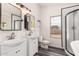 A modern bathroom featuring double sinks, a glass shower, and updated fixtures at 10358 N 78Th Ave, Peoria, AZ 85345