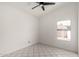 A bright room featuring tile floors, a ceiling fan, and a window showcasing the exterior at 10358 N 78Th Ave, Peoria, AZ 85345