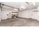 Spacious garage features painted concrete floors, shelving and ample room for storage and parking at 10358 N 78Th Ave, Peoria, AZ 85345
