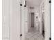 Hallway featuring white doors, tile floors, and modern lighting fixtures at 10358 N 78Th Ave, Peoria, AZ 85345