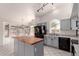 A gourmet kitchen featuring custom cabinets, a wooden island, and stainless steel appliances at 10358 N 78Th Ave, Peoria, AZ 85345