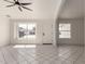 Spacious living room with white walls, large windows, and neutral tile flooring throughout, perfect for relaxing and entertaining at 10358 N 78Th Ave, Peoria, AZ 85345