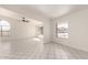 Bright living room boasts tile floors, large windows, and arched doorway, creating a welcoming space for relaxing or entertaining at 10358 N 78Th Ave, Peoria, AZ 85345