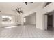 Open living room with neutral tile flooring, perfect for gatherings or relaxing, creating an inviting atmosphere at 10358 N 78Th Ave, Peoria, AZ 85345