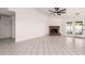 Bright living room featuring a brick fireplace, neutral walls, tile flooring, and a ceiling fan at 10358 N 78Th Ave, Peoria, AZ 85345