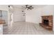 Spacious living room with a brick fireplace, tile flooring, and an open layout with plenty of natural light at 10358 N 78Th Ave, Peoria, AZ 85345