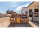 Stone outdoor kitchen features built-in grill and oven, perfect for preparing delicious meals and enjoying outdoor dining at 10358 N 78Th Ave, Peoria, AZ 85345