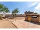 Backyard patio features stone outdoor kitchen and large grassy area, perfect for barbeques and outdoor entertaining at 10358 N 78Th Ave, Peoria, AZ 85345