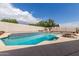 Inviting backyard pool with stone waterfall, and a unique fire pit, perfect for relaxation and entertainment at 10358 N 78Th Ave, Peoria, AZ 85345