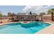 Backyard pool features a fire pit, lush landscaping, and ample lounging areas for outdoor enjoyment at 10358 N 78Th Ave, Peoria, AZ 85345