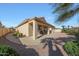 A covered back patio area with plenty of room for entertaining overlooks the landscaped backyard at 10613 E Nacoma Dr, Sun Lakes, AZ 85248