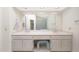 Bathroom featuring a long vanity with double sinks, white cabinets and neutral color palette at 10613 E Nacoma Dr, Sun Lakes, AZ 85248