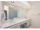 Bathroom featuring a long vanity with double sinks, white cabinets and neutral color palette at 10613 E Nacoma Dr, Sun Lakes, AZ 85248