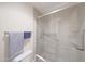Clean bathroom features a shower with glass door and grab bars, and accessible toilet at 10613 E Nacoma Dr, Sun Lakes, AZ 85248