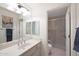 Clean bathroom with laminate counters, a sink, a well-lit mirror, and a shower with glass door at 10613 E Nacoma Dr, Sun Lakes, AZ 85248