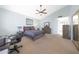 Spacious bedroom featuring carpet, vaulted ceilings, fan, and light blue colored walls at 10613 E Nacoma Dr, Sun Lakes, AZ 85248