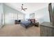 Large bedroom with vaulted ceilings, a ceiling fan, carpet, and a large window at 10613 E Nacoma Dr, Sun Lakes, AZ 85248