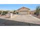Charming single-story home with a two-car garage and well-maintained desert landscaping in front at 10613 E Nacoma Dr, Sun Lakes, AZ 85248