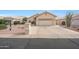 Charming single-story home with a two-car garage and well-maintained desert landscaping in front at 10613 E Nacoma Dr, Sun Lakes, AZ 85248