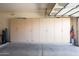 Clean, spacious two-car garage featuring built-in cabinets and storage at 10613 E Nacoma Dr, Sun Lakes, AZ 85248