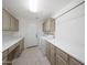 Well-lit laundry room equipped with white appliances, neutral cabinets, and laminate countertops at 10613 E Nacoma Dr, Sun Lakes, AZ 85248