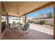 Relaxing covered patio with furniture overlooks a desert landscape, creating a tranquil outdoor space at 10613 E Nacoma Dr, Sun Lakes, AZ 85248