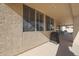 Covered patio, with views of other patios, includes a barbeque, seating and shade screens at 10613 E Nacoma Dr, Sun Lakes, AZ 85248