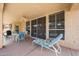 Covered patio with lounge chair, table, and seating, for a tranquil outdoor living space at 10613 E Nacoma Dr, Sun Lakes, AZ 85248