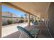 Covered patio with seating area and ceiling fan overlooks a desert landscaped backyard at 10613 E Nacoma Dr, Sun Lakes, AZ 85248