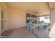 Covered patio boasts a ceiling fan and seating with comfortable cushions, offering a relaxing outdoor space at 10613 E Nacoma Dr, Sun Lakes, AZ 85248