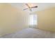 Cozy bedroom featuring ceiling fan, carpet, and a bright window at 10619 N 38Th Ave, Phoenix, AZ 85029