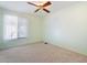 Comfortable bedroom featuring ceiling fan, carpet, and a bright window at 10619 N 38Th Ave, Phoenix, AZ 85029
