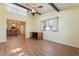 Comfortable bedroom with wood floors, exposed beam, and views into the adjacent kitchen at 10619 N 38Th Ave, Phoenix, AZ 85029