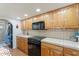 Well-lit kitchen featuring wood cabinets, appliances, and ample counter space at 10619 N 38Th Ave, Phoenix, AZ 85029