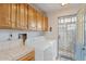 Functional laundry room with built-in cabinets, washer, dryer, and access to the outdoors at 10619 N 38Th Ave, Phoenix, AZ 85029