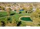 Aerial view of a meticulously maintained golf course with manicured greens, mature trees, and water features at 11000 N 77Th Pl # 2042, Scottsdale, AZ 85260