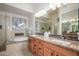 Luxurious bathroom with a soaking tub, dual vanities, and elegant granite countertops at 11000 N 77Th Pl # 2042, Scottsdale, AZ 85260