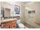Well-lit bathroom with glass shower, neutral-toned tile, and vanity at 11000 N 77Th Pl # 2042, Scottsdale, AZ 85260