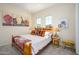 Cozy bedroom features a wooden bed frame, two windows, and stylish decor at 11000 N 77Th Pl # 2042, Scottsdale, AZ 85260