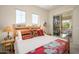 Bright bedroom with natural light, wood bed frame, and access to outdoor patio at 11000 N 77Th Pl # 2042, Scottsdale, AZ 85260