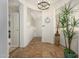 Inviting entryway with decorative lighting, tile flooring, and staircase with shutters at 11000 N 77Th Pl # 2042, Scottsdale, AZ 85260