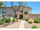 Elegant home with manicured landscaping, a curved walkway, and stately trees at 11000 N 77Th Pl # 2042, Scottsdale, AZ 85260