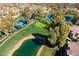 Aerial view of a scenic golf course with ponds, mature trees and single Gathering homes surrounding it at 11000 N 77Th Pl # 2042, Scottsdale, AZ 85260