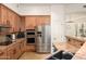 Charming kitchen includes stainless appliances, granite counters, wood cabinets, and a breakfast bar at 11000 N 77Th Pl # 2042, Scottsdale, AZ 85260