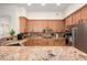Well-equipped kitchen featuring granite countertops, stainless steel appliances, and ample wood cabinetry at 11000 N 77Th Pl # 2042, Scottsdale, AZ 85260