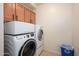 Functional laundry room features a stacked washer and dryer and storage at 11000 N 77Th Pl # 2042, Scottsdale, AZ 85260