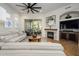 Cozy living room with fireplace, access to patio, and views of the outdoor landscape at 11000 N 77Th Pl # 2042, Scottsdale, AZ 85260